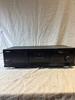 Front view of the Teac Model V-370 cassette deck showing cassette compartment, control buttons, LED indicators, and brand name.