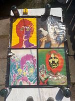 Full view of the Beatles psychedelic four-panel poster laid flat on a table outdoors under sunlight showing overall condition and damage to edges