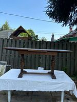 Side view of the oak dining table showing table top and turned legs detail.