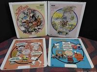 Front covers of 4 Charlie Brown Peanuts record albums with colorful cartoon illustrations