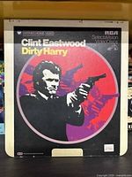 Front cover of Dirty Harry RCA SelectaVision VideoDisc featuring Clint Eastwood with a gun in a red and purple target design