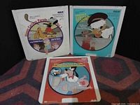 Front covers of three vintage Walt Disney record albums with Donald Duck and friends.