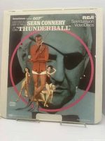 Front cover of RCA SelectaVision VideoDisc featuring Sean Connery in 'Thunderball' with illustrated characters and large James Bond face background.