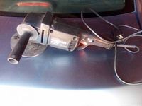 Full view of the black Craftsman disc sander-polisher showing side handle, power cord, and sanding disc.