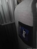 Side view of the mattress showing Sealy Posturepedic logo patch on fabric cover.