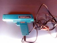 Full view of blue Super-Bright Timing Light device with power cord laid out beside it.