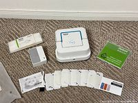 Main robot, dock, two batteries, sealed microfiber pads, disposable pads, manuals laid out together