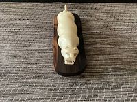 Top view of carved panther sculpture on wooden base, showing detailed head and body shape.