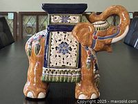 Side view of the ceramic elephant showing detailed patterns and colors