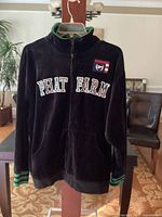 Front view of black Phat Farm sweatshirt jacket with full zipper, embroidered logo, and green striped collar and cuffs.