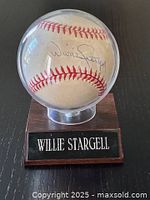 Baseball signed by Willie Stargell displayed in a clear protective case with a wooden base and nameplate.