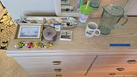 Overview of all items on wooden dresser including drinks and decorative items