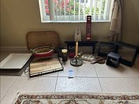Full lot items arranged on floor including trays, baskets, candles, incense sticks, and candle holders