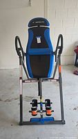 Front view of the Exerpeutic inversion table showing the padded backrest, ankle supports, and frame.