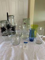All vases and canisters grouped together to show entire lot contents, includes various shapes and colors as described in details.