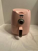 Front view of pink Bella air fryer showing dial and handle