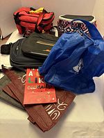 Overview of assorted bags including insulated coolers, laptop bag and folded totes