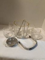 entire set showing bucket, four glasses, tongs, handle, disc