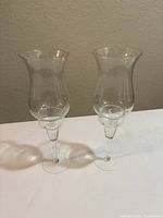 Two assembled hurricane candleholders side by side