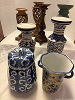 group shot of all candle holders and vases