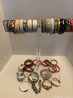 Full view of 29 bangles on display stand and additional bracelets on tabletop