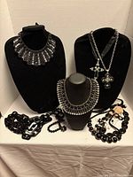 Group view of all jewellery pieces on busts