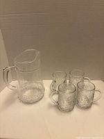 Group shot of pitcher and four mugs