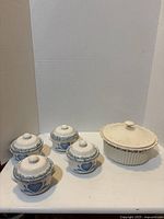 Group shot of casserole dish and four soup crocks