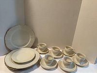 Full set of cups, saucers, plates displayed