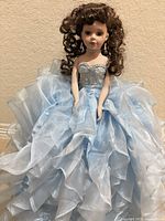 Front view of porcelain doll showing dress and face