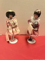 Both Avon porcelain dolls on stands