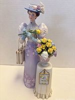 Front view of Mrs. Albee figurine with pedestal and flowers