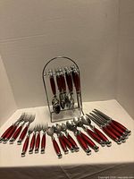 Full set displayed on table with rack holding utensils