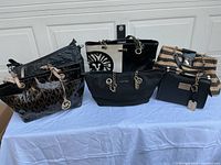 All five handbags displayed on table