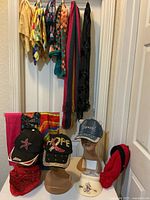 Group view of scarves hanging and hats displayed