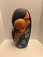 front view showing mother holding child design and overall form