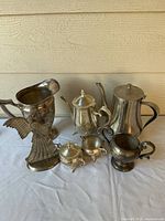 Group view of all six silver-tone pieces