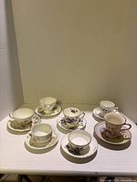 Group shot of seven cup and saucer sets