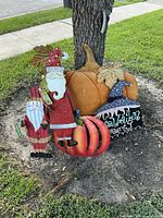 All four yard signs grouped at tree base