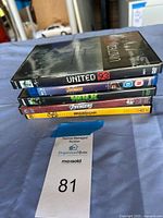 Stack of five movie cases showing titles United 93, Avengers Assemble (Blu-ray), The Incredible Hulk (DVD), The Avengers (DVD), Spider-Man: Homecoming (DVD).