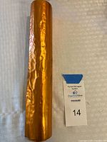 Copper sheet roll upright showing metallic orange/copper color and surface creases.