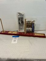 Full view of Deluxe E-Z BowMaker tool, instruction manual, and bag of assorted ribbon spools