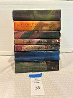 Full stack of seven hardcover Harry Potter books with dust jackets visible from the front.