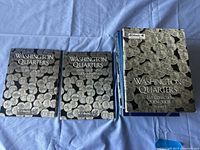 Three folders laid flat: two Washington Quarters volumes and one Washington Quarters 2004–2008 folder.