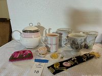 Full lot showing Mary Kay tea pot, four tea cups, pin, beaded coin purse, and rose-shaped jewelry box