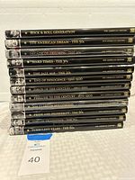 Stacked photo of 12 hardcover books from the 'Our American Century' series by Time Life showing their spines and titles.