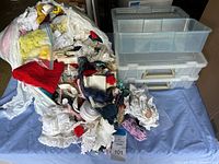 Overview of the assortment of sewing trims including lace, ribbons, and fabric pieces alongside the three clear plastic organizers.