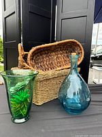 Overall lot: three baskets, green vase with faux succulents, blue glass bottle