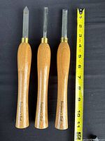 Three Benjamin's Best chisels beside tape for scale