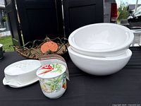 Full lot showing bread basket with terracotta warmer, Brie baker, condiment jar and two bowls